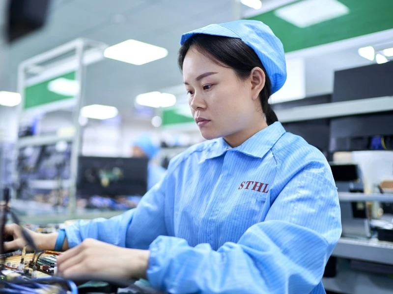 STHL technician operating a PCBA functional test workstation